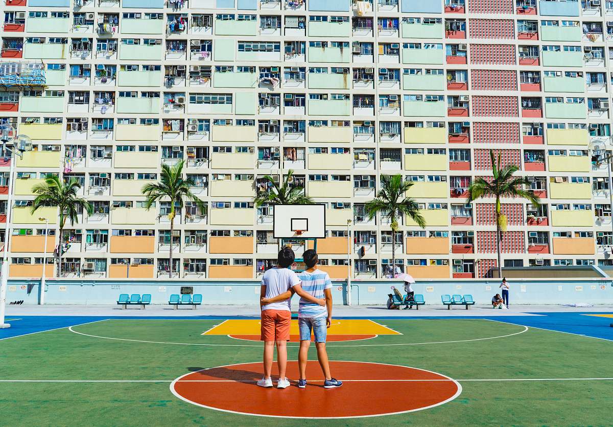 basketball court minimalist photography of two men standing on basketball court looking upwards sports